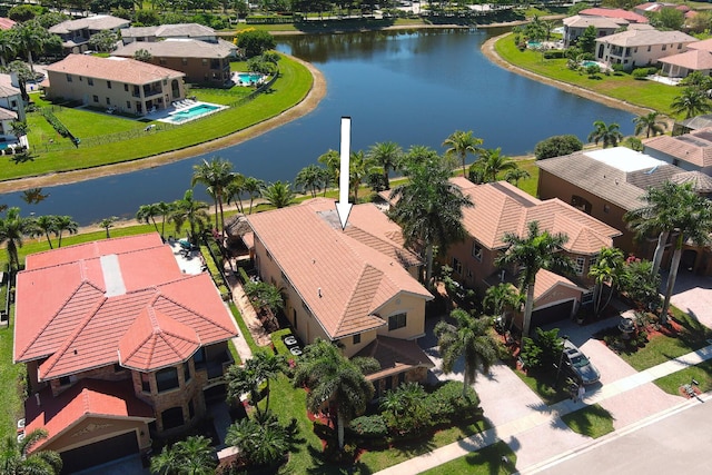 drone / aerial view featuring a residential view and a water view