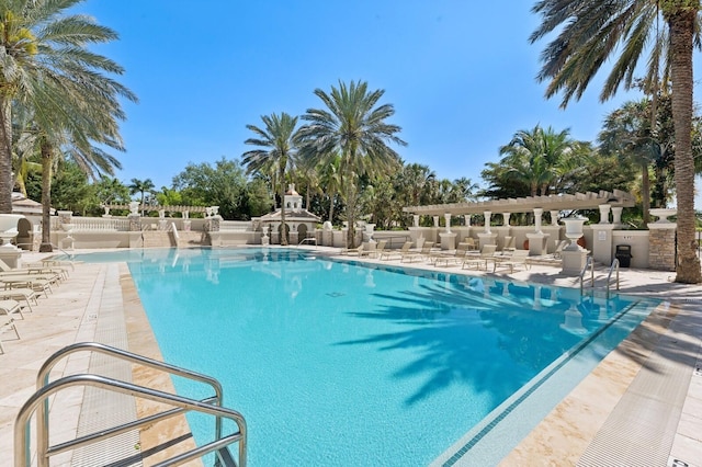 community pool with fence, a patio area, and a pergola