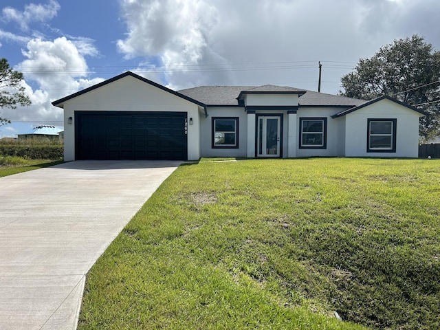 view of front of property with a garage, driveway, a front lawn, and roof with shingles