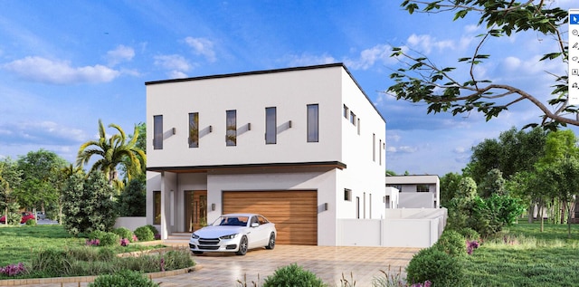 modern home featuring a garage, fence, decorative driveway, and stucco siding