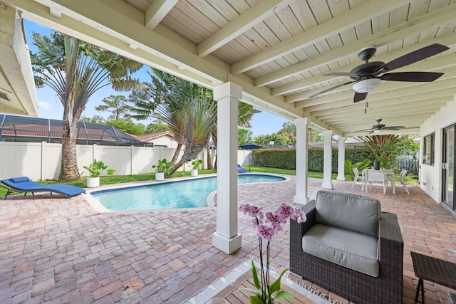 view of swimming pool with a ceiling fan, a patio area, a fenced backyard, and a fenced in pool