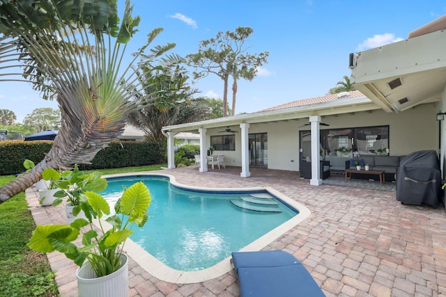 view of swimming pool featuring a fenced in pool, a ceiling fan, a patio, grilling area, and an outdoor living space