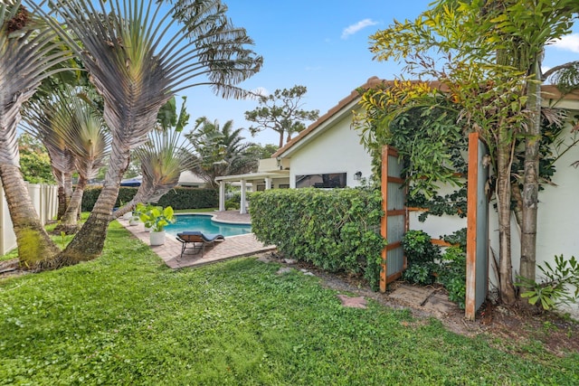 view of yard featuring a patio area, fence, and a fenced in pool