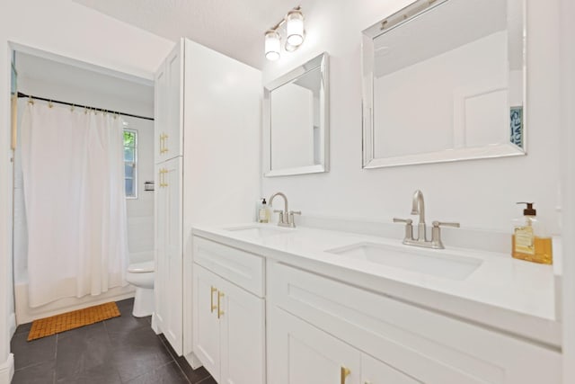 full bath with tile patterned flooring, a sink, toilet, and double vanity