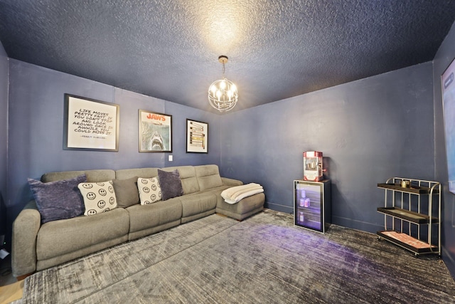 carpeted living room featuring a textured ceiling, baseboards, and a notable chandelier