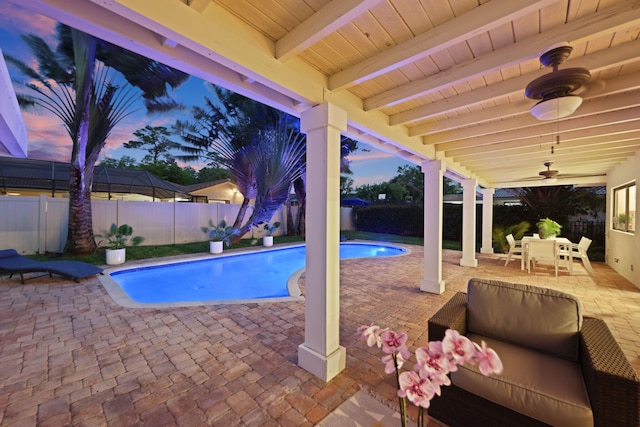 view of swimming pool featuring a fenced in pool, a fenced backyard, a patio, and ceiling fan