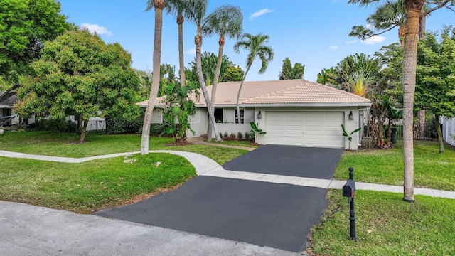 ranch-style house with a garage, driveway, a tile roof, and a front yard