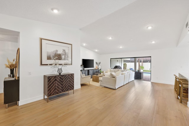 living room with light wood-style flooring, baseboards, vaulted ceiling, and recessed lighting