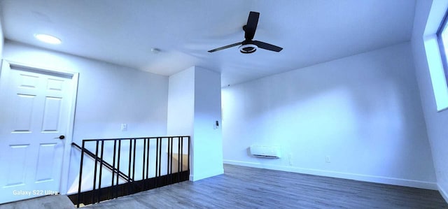 spare room featuring ceiling fan, wood finished floors, and baseboards