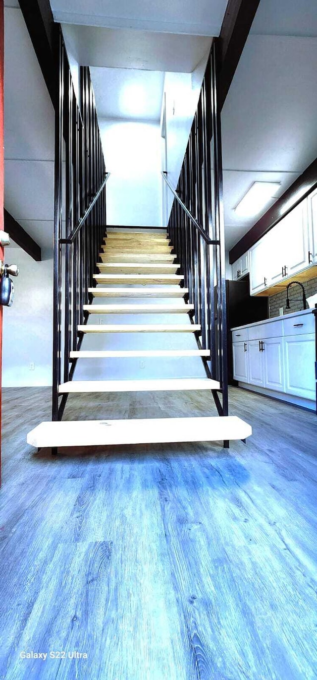 stairway with wood finished floors