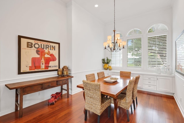 dining area featuring crown molding, recessed lighting, a chandelier, and dark wood finished floors