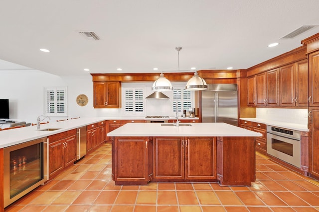 kitchen with visible vents, wine cooler, appliances with stainless steel finishes, and a sink