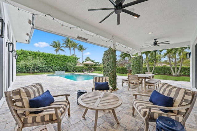 view of patio with outdoor dining area, a ceiling fan, and a fenced in pool