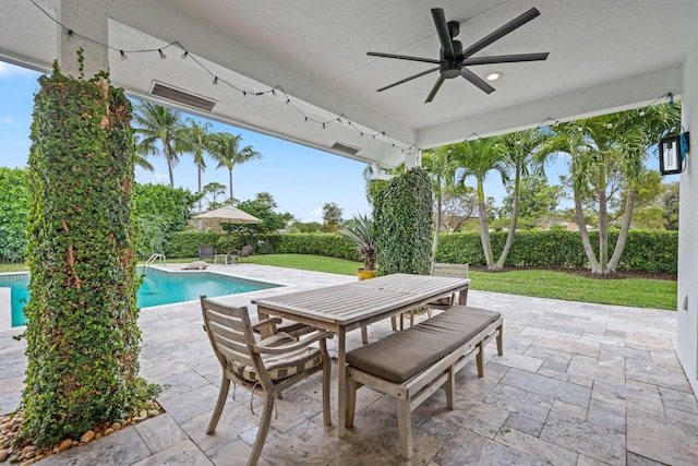 view of patio / terrace featuring a fenced in pool, outdoor dining area, and ceiling fan