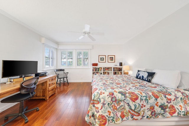 bedroom with ceiling fan, ornamental molding, wood finished floors, and baseboards