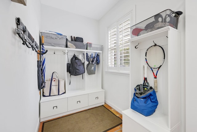 mudroom featuring baseboards and wood finished floors