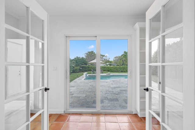 doorway with light tile patterned flooring and french doors