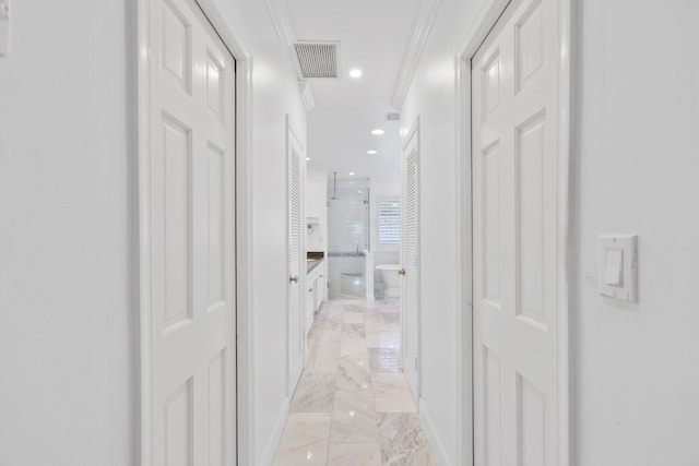 hallway with marble finish floor, recessed lighting, visible vents, and ornamental molding