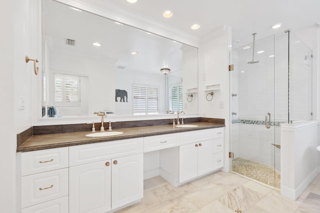 full bathroom featuring double vanity, a sink, visible vents, and a shower stall