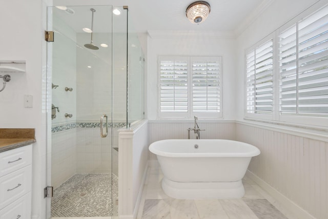 bathroom featuring a wainscoted wall, a shower stall, ornamental molding, and a wealth of natural light