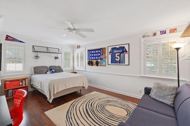 bedroom with ceiling fan, a textured ceiling, baseboards, and wood finished floors