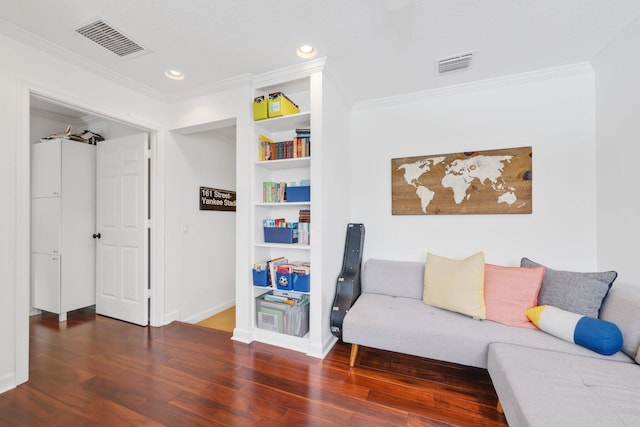 sitting room featuring wood finished floors, visible vents, and crown molding