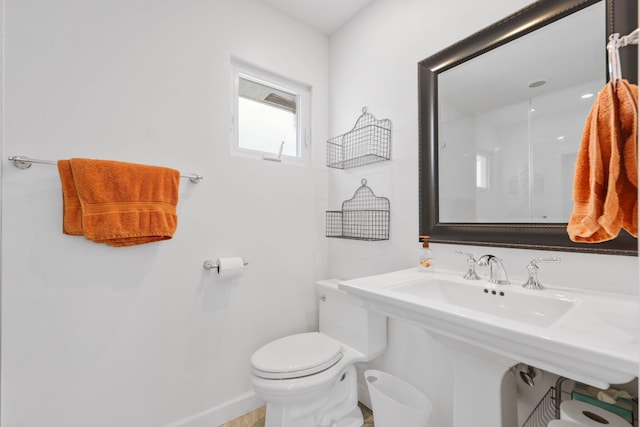 bathroom with toilet and baseboards