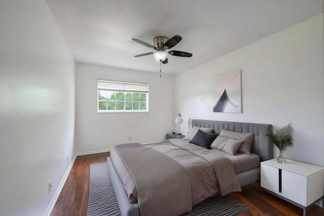 bedroom with wood finished floors, a ceiling fan, and baseboards