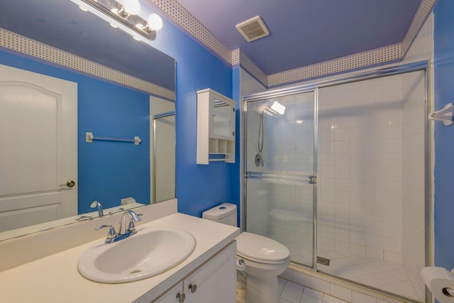 bathroom with toilet, a shower stall, visible vents, and vanity