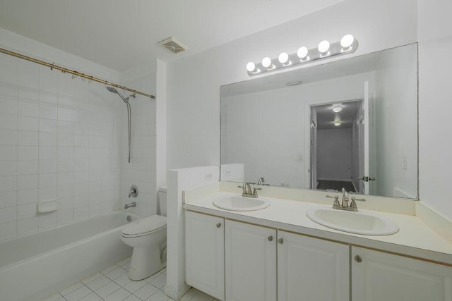 bathroom with toilet, visible vents, a sink, and tile patterned floors