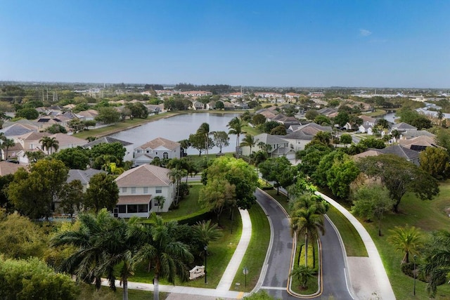 drone / aerial view with a water view and a residential view