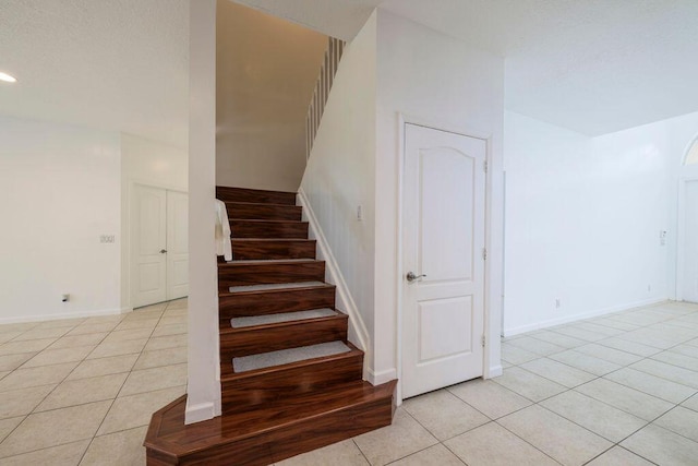 stairs with recessed lighting, baseboards, and tile patterned floors