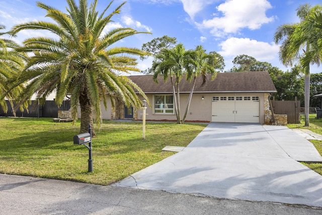 view of front of house featuring stucco siding, an attached garage, a front yard, fence, and driveway