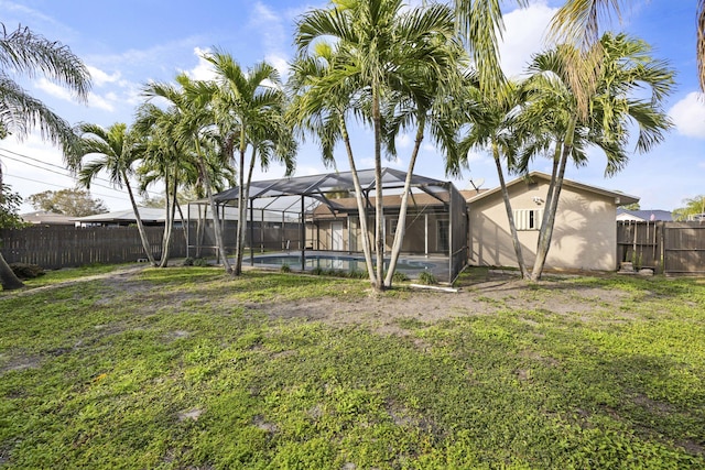 view of yard featuring a fenced in pool, a lanai, and a fenced backyard