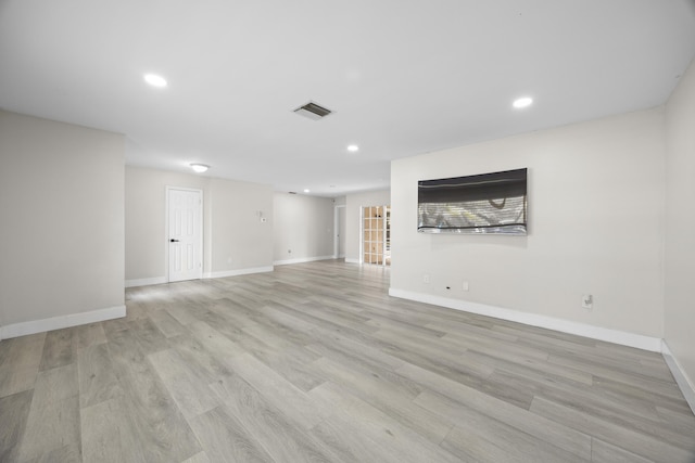 below grade area featuring recessed lighting, baseboards, visible vents, and light wood finished floors