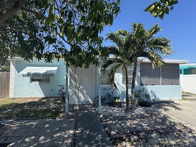 view of property exterior featuring fence and stucco siding