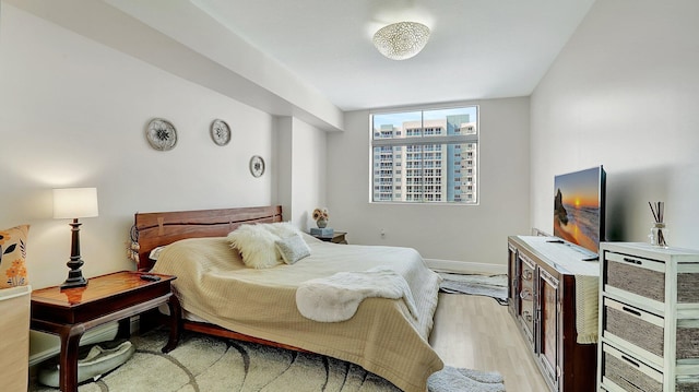 bedroom featuring light wood-style flooring and baseboards