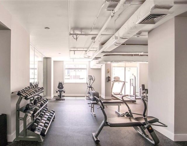 workout area with baseboards and visible vents