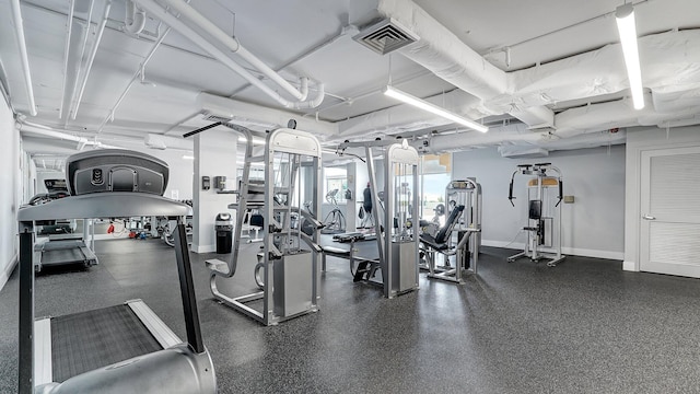 exercise room featuring baseboards and visible vents