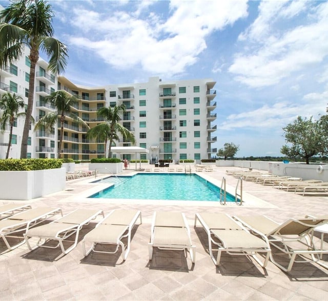 community pool with a patio area