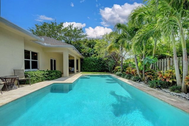 view of swimming pool with a fenced in pool, fence, and a patio