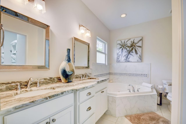 full bath with tile patterned flooring, toilet, a sink, double vanity, and a tub with jets