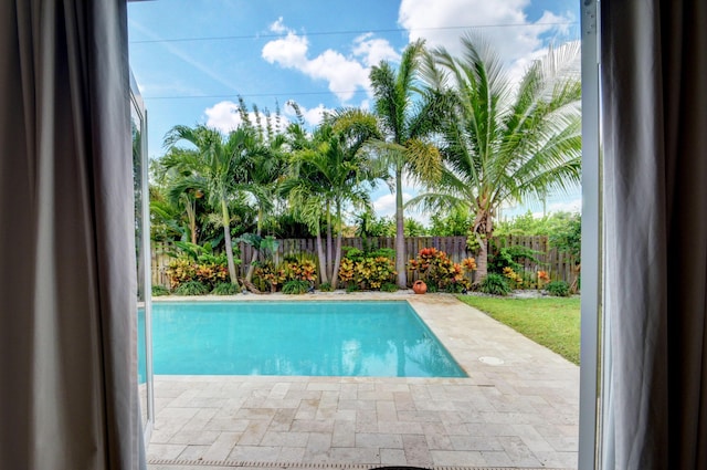 view of pool featuring a fenced backyard, a fenced in pool, and a patio