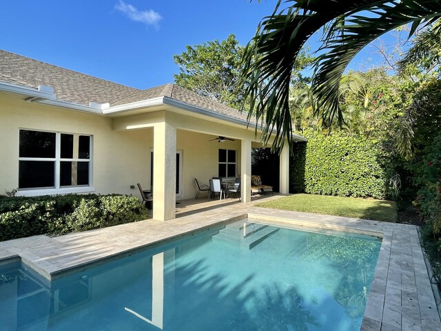 pool with a patio area and ceiling fan