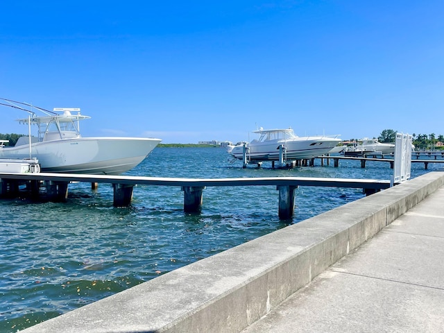 dock area with a water view and boat lift