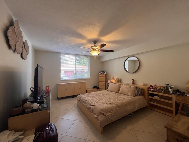 700 Scotia Dr Unit 103, Hypoluxo, FL 33462 - bedroom featuring a ceiling fan, a textured ceiling, and light tile patterned flooring