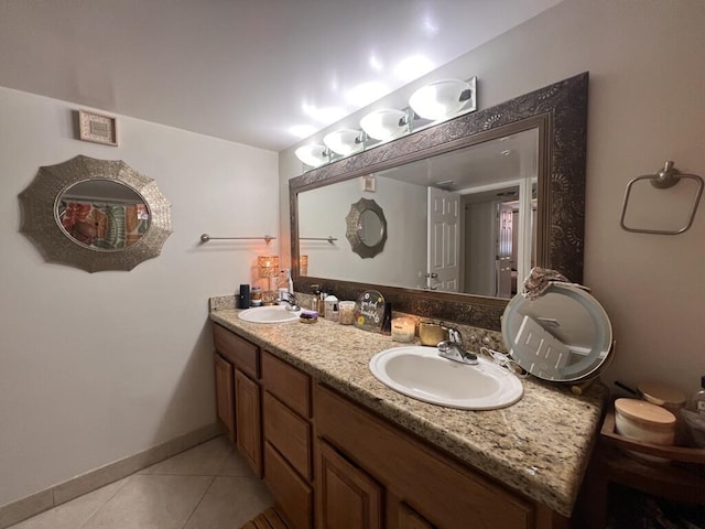 700 Scotia Dr Unit 103, Hypoluxo, FL 33462 - bathroom featuring baseboards, double vanity, a sink, and tile patterned floors