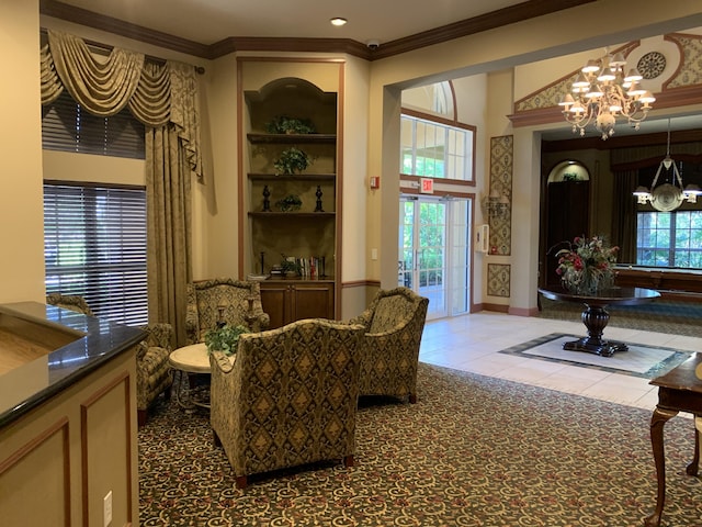 700 Scotia Dr Unit 103, Hypoluxo, FL 33462 - living area featuring crown molding, baseboards, a notable chandelier, and tile patterned floors