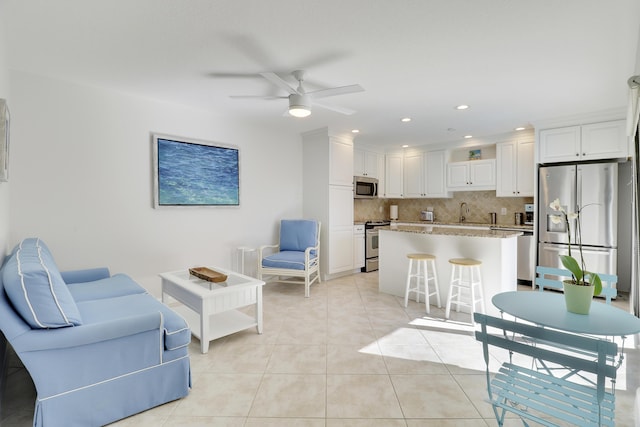 living area featuring light tile patterned floors, recessed lighting, and ceiling fan