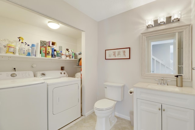 bathroom with tile patterned flooring, baseboards, washing machine and dryer, toilet, and vanity